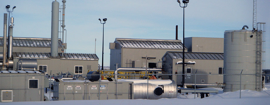 A photo of a Compressor plant in alberta in the winter cool colors