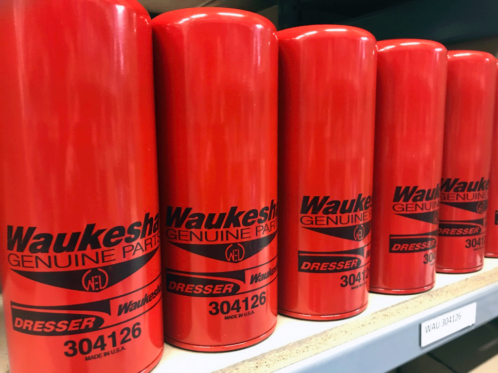 An image of serveral Waukesha oil fillters in a line