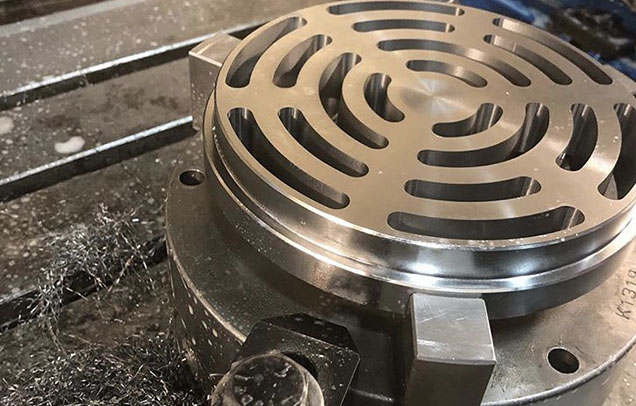 Haas VF4 Mill at work Haas VF4 mill making a compressor valve with metal flying off to the side