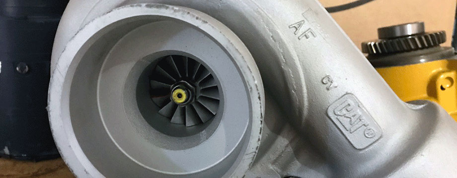 Caterpillar 3306 Turbocharger in front of a Cat waterpump and TDI starter for a Cat 3306